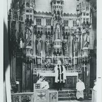 priest within a church apse