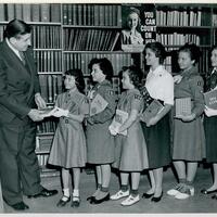 Hermann F. Robinton, the Seaford Public Library's first director, with Seaford Girl Scouts (left to right) Sharon Baras, Susan Friedman, Georgianna McCahill, Barbara Gross, Margaret Fischer, and Nancy Fowler. (1958)