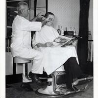 Barber Mike Salerno in his shop cutting hair (1952)