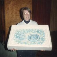 Cake being presented at the 100th anniversary.