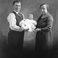 Two parents holding baby