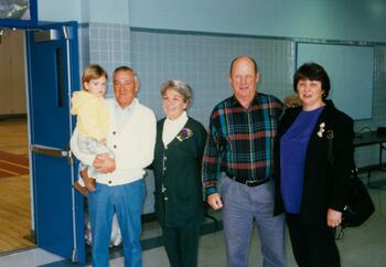Four adults and one child in school. 