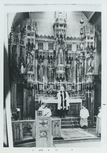 priest within a church apse