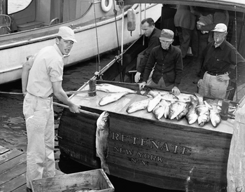Carl Darenberg, Sr., the donor of this collection, stands in front of his boat, Foretenate.