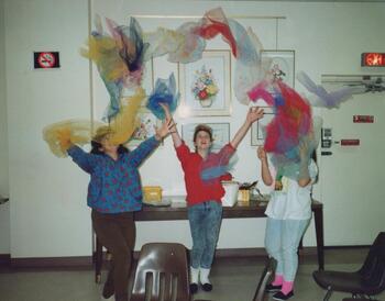Teens dramatically tossing dancing scarves up in the air during a Teens and Tots program in 1991.